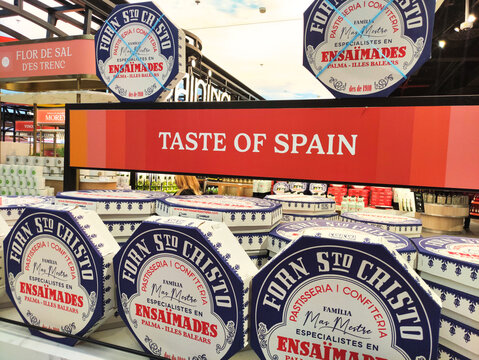 Palma De Mallorca, Spain - April 05, 2026: Taste of Spain display featuring traditional Ensaimadas pastries in decorative packaging at a gourmet food market