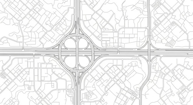 Aerial view of a complex highway interchange and surrounding city grid.