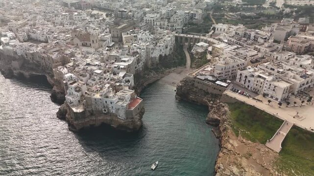 Aerial View of Polignano a Mare with Historic Buildings and Crowded Beach, Puglia, Southern Italy