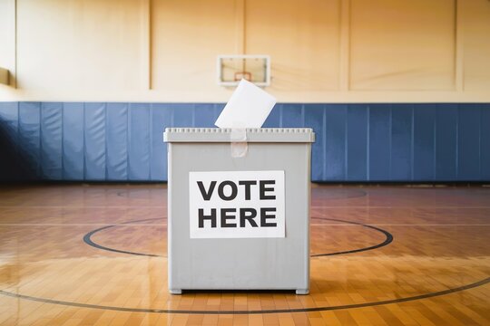 ballot box with vote here sign in school gymnasium. Student council election campaign