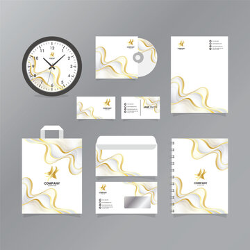 corporate branding set with gold and white swirls on gray background
