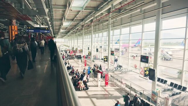 Tirana, Albania - 15th april, 2026:timelapse bustling panorama modern airport terminal with passengers sit waiting by gates. Transportation costs, summer travel flights. Motion blur intentional effect