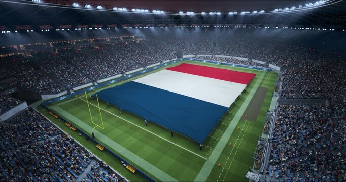Professional Stadium With American Football Game Championship With Flag of France Spread Across the Pitch Before Football Match Start. Cheering Crowds of Fans Surround the Field. Static Wide Shot.