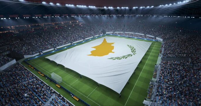 Professional Stadium Soccer Game Championship With Flag of Cyprus Spread Across the Pitch Before Football Match Start. Cheering Crowds of Fans Surround the Field. Aerial Elevated Static Wide Shot.