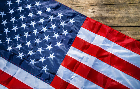 American flag draped on rustic wooden plank surface