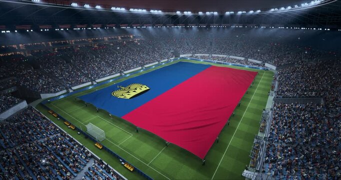 Professional Stadium Soccer Game Championship With Flag of Liechtenstein Spread Across the Pitch Before Football Match Start. Cheering Crowds of Fans Surround the Field. Aerial Elevated Static Wide