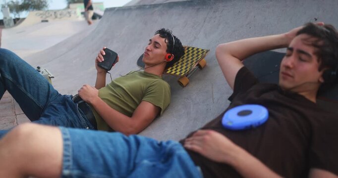 Young friends listening music with cassette and cd player - New trend, people lifestyle and vintage analog devices