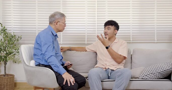 senior asian therapist talk with asian man during counseling session at mental health clinic, listening his emotional explanation, guiding through self reflection, stress recovery, communication