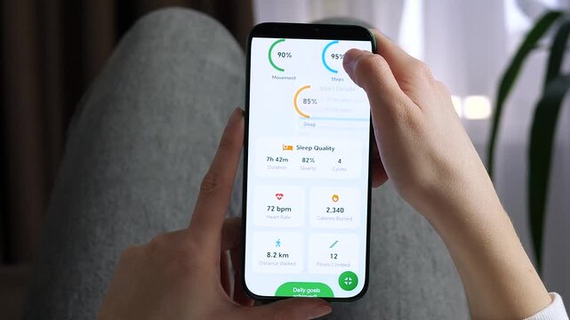 Achieving fitness goals through digital tracking. A person monitors sleep analysis and daily step count on a smartphone app. Great for motivational videos, health tech advertisements, and wellness