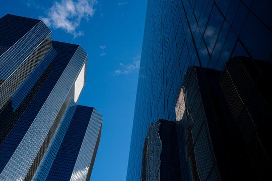 Glass tower architecture skyscraper office with deep shadows and bold perspective looking up in France La Defense financial quarter highrise