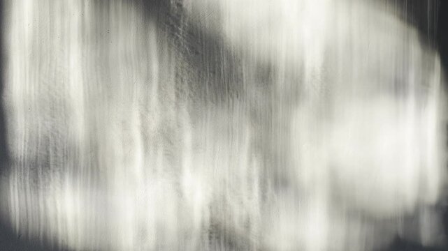 monochrome abstract light play dances across textured grey wall with soft blurred shadows creating moody cinematic atmosphere