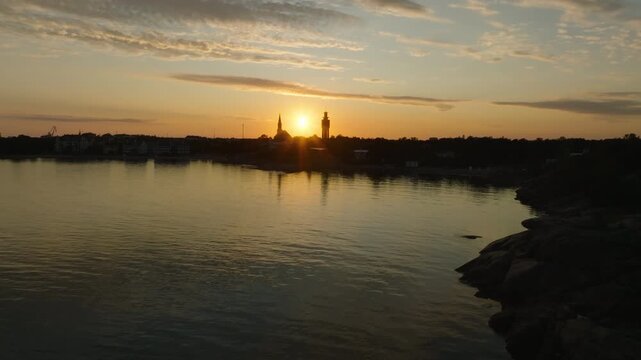 Establishing drone shot approaching the skyline of Hanko, sunset in Finland