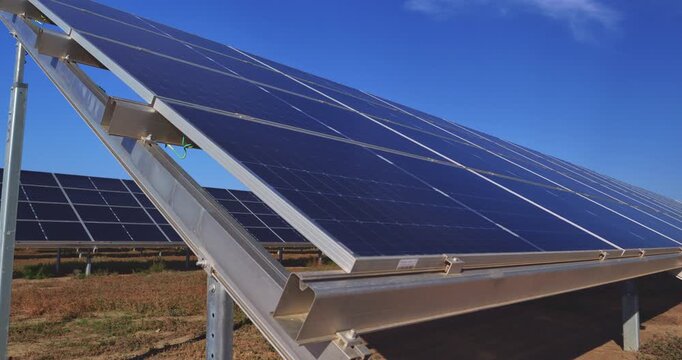 Close up of photovoltaic solar panels on metal support structure at a renewable energy farm Clean power infrastructure under blue sky with sustainable electricity generation and green technology conce