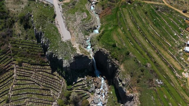 Aerial drone shot of a beautiful waterfall in Faraya Lebanon with rocky cliffs and green nature landscape