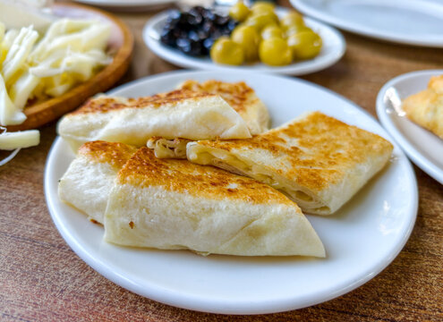 Delicious flatbreads with cheese served on a plate with sides at a local eatery during lunchtime