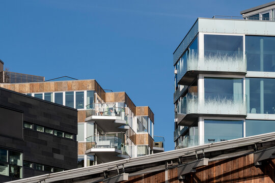 Modern apartments architecture in Oslo Norway with balconies and rooftop lines showing minimal skyline and open space on clear daylight background