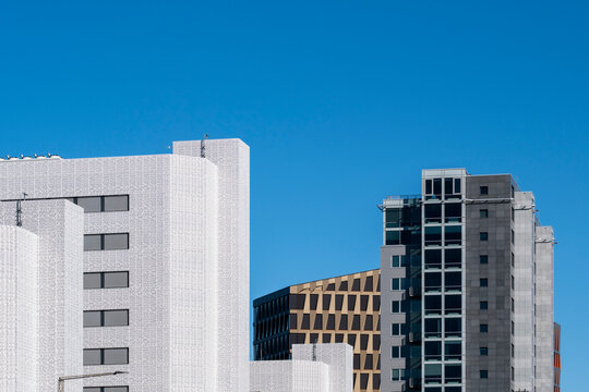 Blue minimal architecture skyline in Oslo Norway with modern towers and generous copy space on clean daylight background for posters and branding