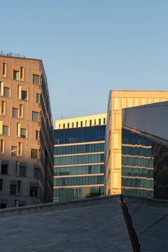 Glass reflections on modern architecture building in Oslo Norway with strong perspective plus minimal skyline and open space on clear daylight background