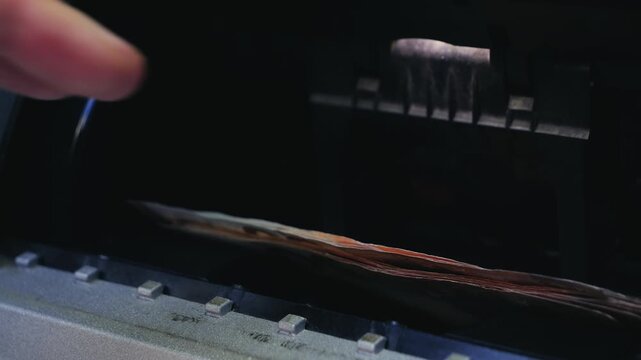 A close-up of a hand withdrawing cash from an ATM, symbolizing money, banking, and financial transactions. High quality 4k footage