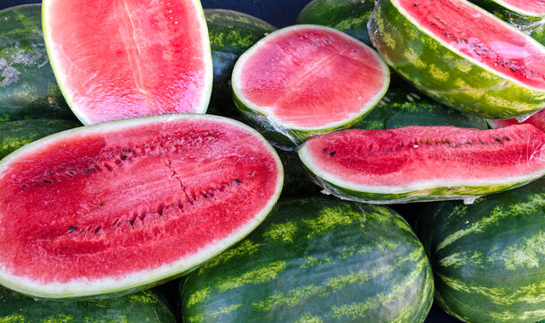Fresh watermelons cut and displayed at a market during summer season
