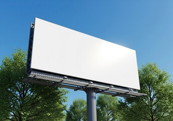 Fototapeta premium Blank billboard sign in the daytime with blue sky and green trees