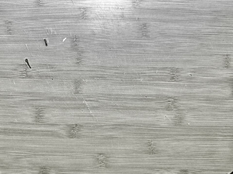worn bamboo cutting board texture with deep knife scratches and dark gashes for natural food preparation background