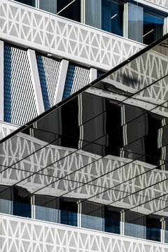 Abstract facade study of modern architecture where windows texture pattern and geometry lines create contrast in a minimalist urban rhythm
