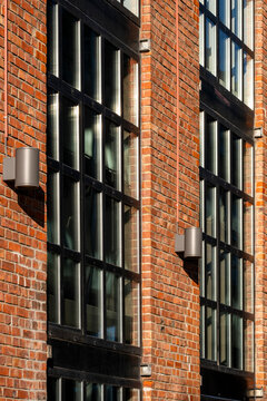 Abstract exterior architecture of modern brick facade where windows lines and geometry meet shadows for a quiet urban building detail