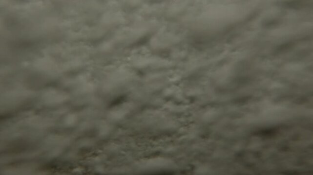 Underwater split level on coastal storm waves cover pebble beach and forms a lots air bubbles which dissolving in water and enriching coastal sea zone with oxygen, Close-up, Slow motion