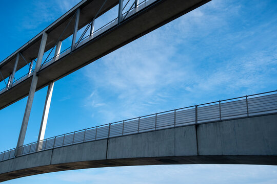 Steel bridge architecture creates a modern minimal scene with sky perspective and sharp lines shaping a refined structure and quiet connection