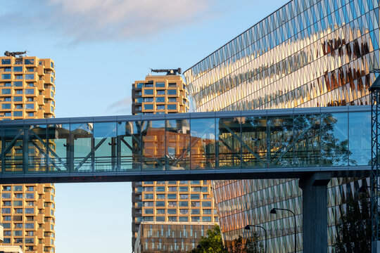 Modern glass and steel pedestrian bridge links Stockholm city towers shaping a calm skyline connection with strong architecture and clean lines