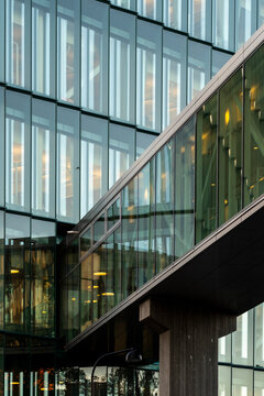 Geometric modern bridge architecture features glass facade reflection with urban lines forming a precise structure and elegant contemporary city mood