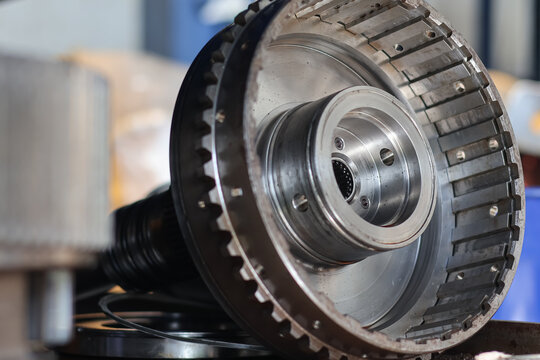 A close-up view of a metallic clutch hub and drum assembly for an Allison automatic transmission, showing the internal splines and precision-engineered steel components.