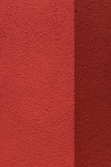 Fototapeta premium Red stucco wall split with vertical edge