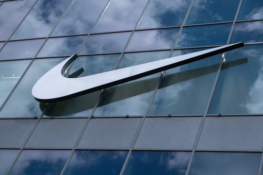 Nike Logo on Glass Building Facade with the sky reflection