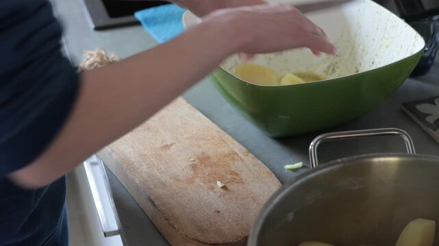 Preparing potatoes for cooking in a kitchen setting