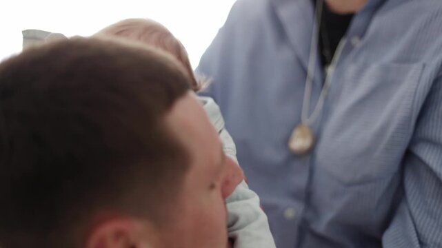 Tender moment of parent holding crying baby with soft light and gentle touch