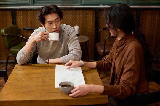 Over cups of fine tea, a couple shares conversation and a good book in a tranquil tea house