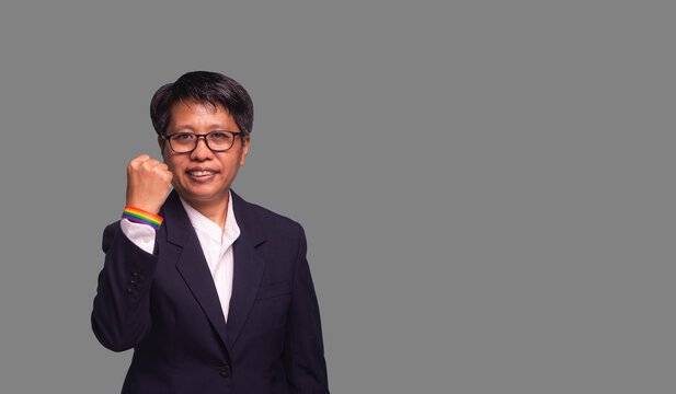 Short-haired businesswoman showing confidence fist in studio