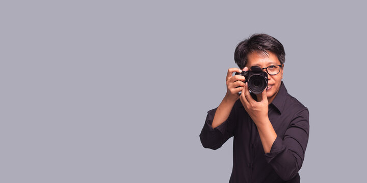 Androgynous photographer taking photo in studio setting