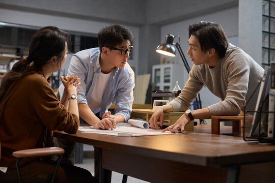The team works late into the evening to meet a deadline