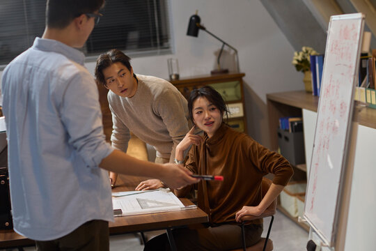 The team works late into the evening to meet a deadline