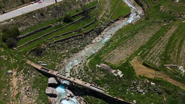 Aerial drone shot of a beautiful waterfall and river in Faraya Lebanon with rocky cliffs and green nature landscape