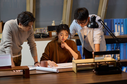 The team works late into the evening to meet a deadline