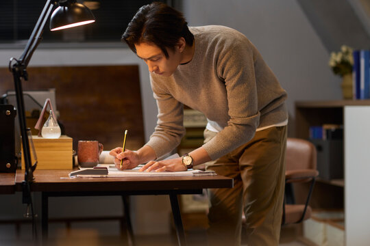 Businessman works late into the evening to meet a deadline