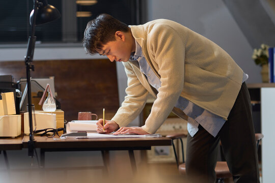 Businessman works late into the evening to meet a deadline