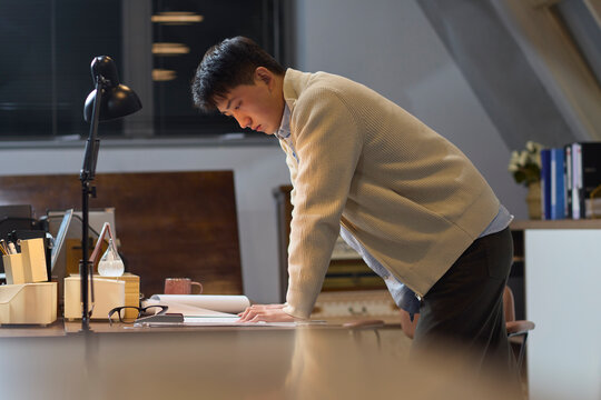 Businessman works late into the evening to meet a deadline