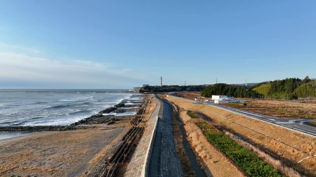 Aerial overview of post-disaster reconstructed seawall and coastline at Tomioka, Fukushima