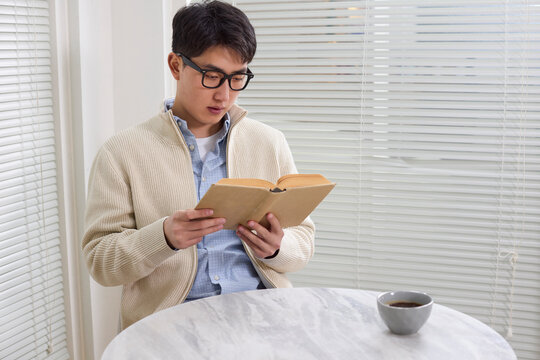 A businessman pauses for a coffee break at his workplace