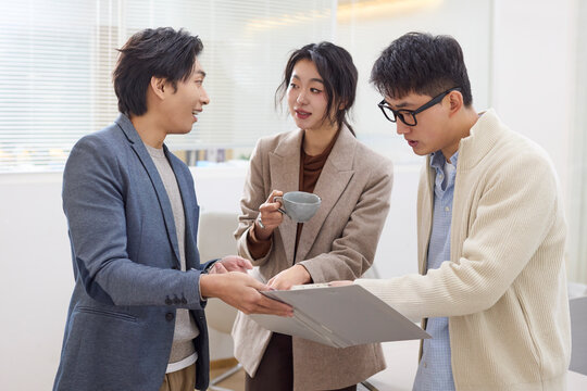 A group of professionals collaborates during a meeting at the office